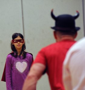 A Fort Plain student roleplays as a superhero during an assembly at Harry hoag Elementary school.