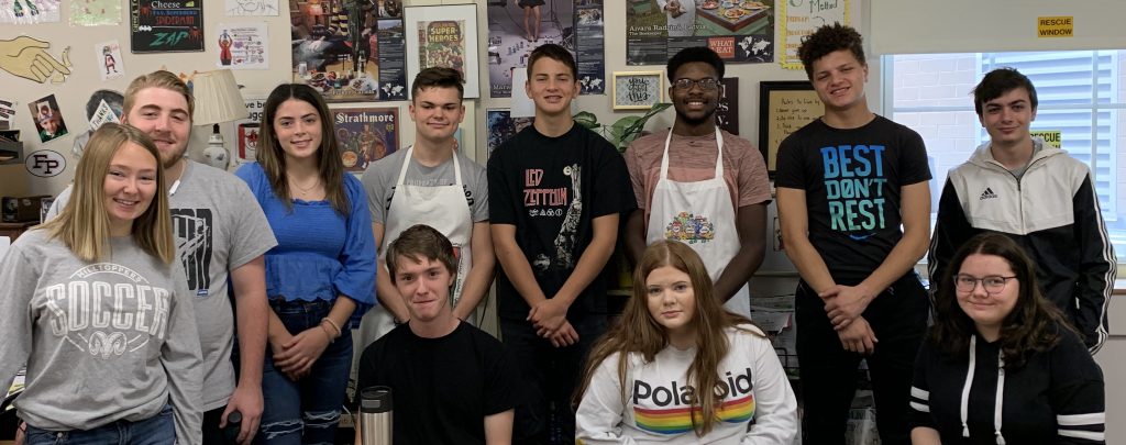 group of high school students pose for a photo in a food science classroom