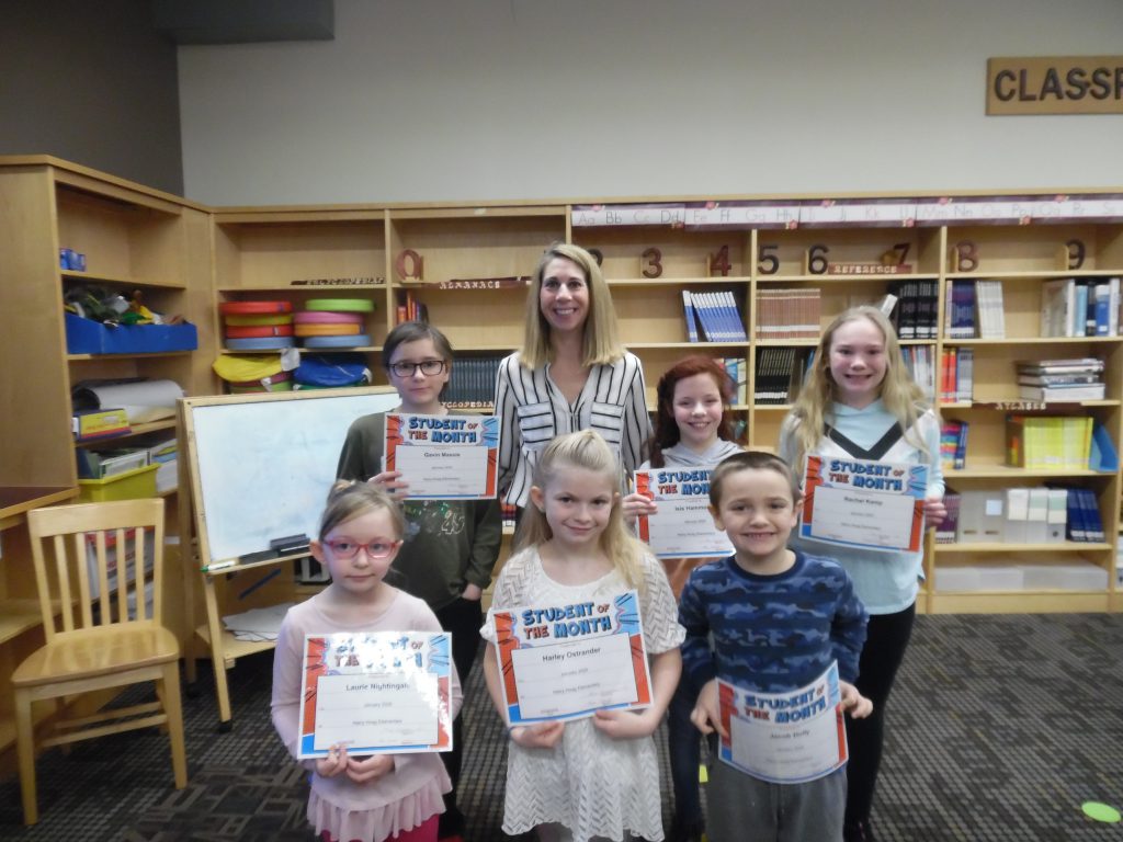 six students pose with certificates in a school library with the principal