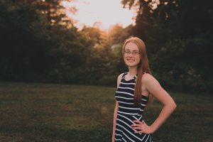 high school student poses outside for a portrait