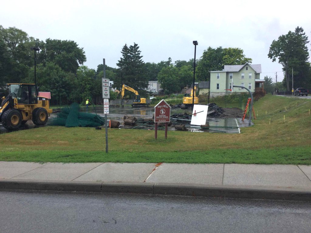 construction equipment removes surface of tennis court at high school