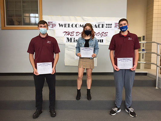 three students holding certificates