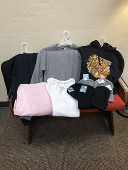 hoodies and shirts folded on a table