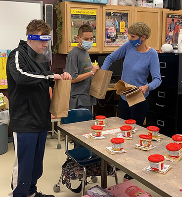 Life Skills students packing Snack Bags in their classroom with teacher Lisa Petty