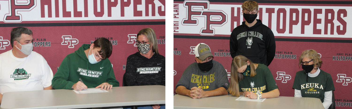 Troy and Sarah seated at table signing commitment letters