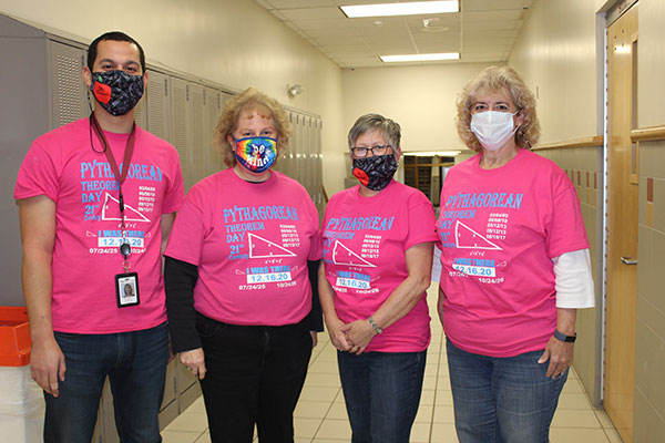 four math teachers wearing t-shirts about Pythagorean Theorem Day