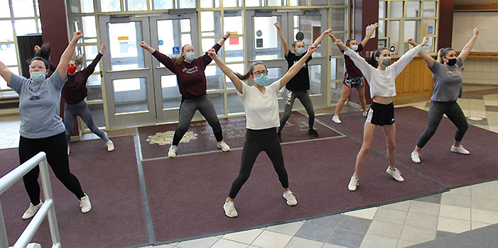 cheerleaders practicing in HS lobby