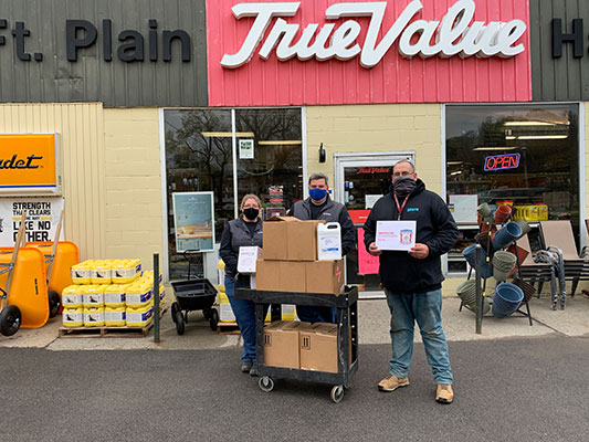 Tanya Kilmartin, Shawn Kilmartin and Matt Hearn with donations in front of store