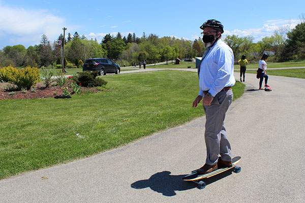 Superintendent on a longboard