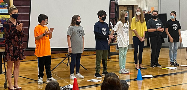 Mrs. Macherone, students, Principal Crisman standing in a line