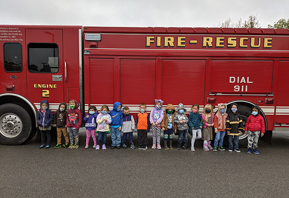 Pre-K students standing in front of fire truck