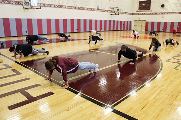 Students doing push-ups in the gym