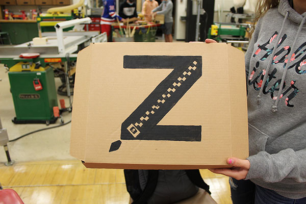 hands holding packaging box with student-designed logo