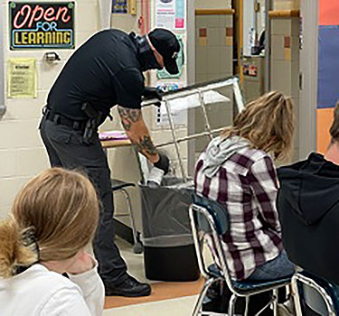 Corporal Richards spraying a window pane