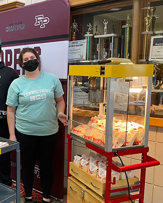 student with popcorn cart