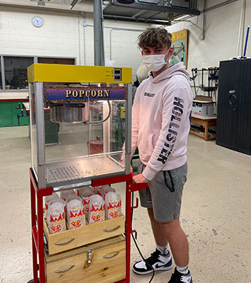 student with popcorn cart