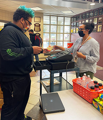 student selling popcorn in the store