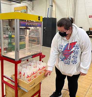 student showing how trays work on the cart