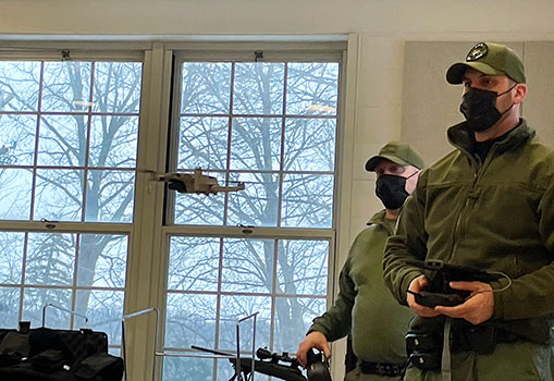 officers flying a drone in the classroom