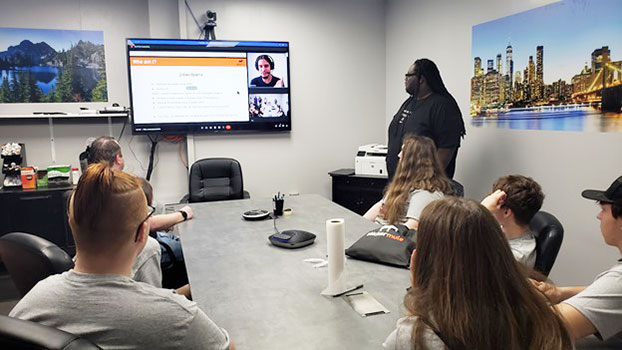 students with Sticker Mule staff in conference room