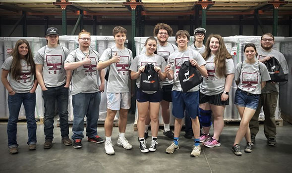 group of students standing holding their swag bags