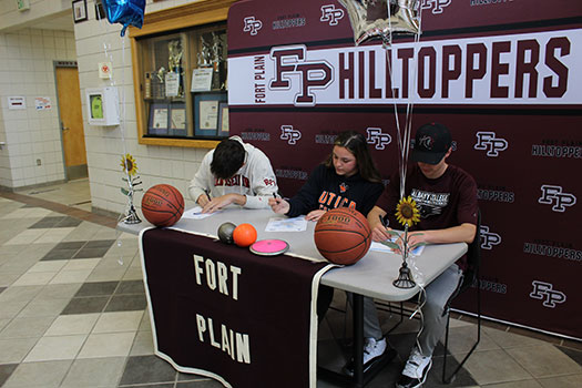 Robert, Sarah and Levi signing their letters