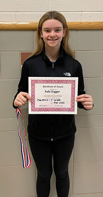 Kala Clapper holding her certificate