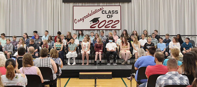 students seated on stage