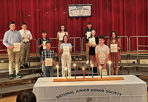students holding certificates at NJHS ceremony