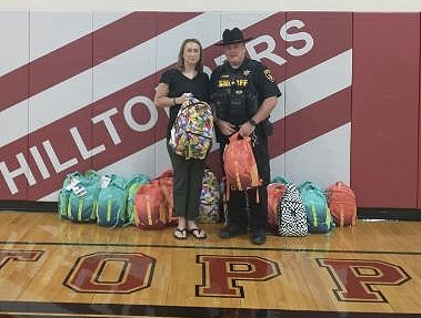 Principal and Sheriff with backpacks