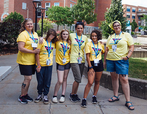 3 adults and 3 students standing in a group