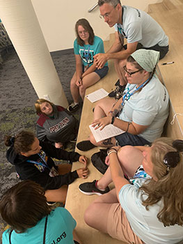 group of students and adults sitting and talking