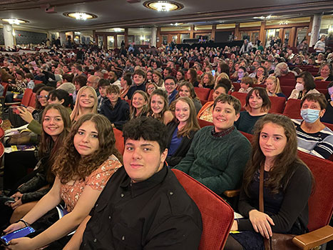 students and staff sitting in seats at Proctors