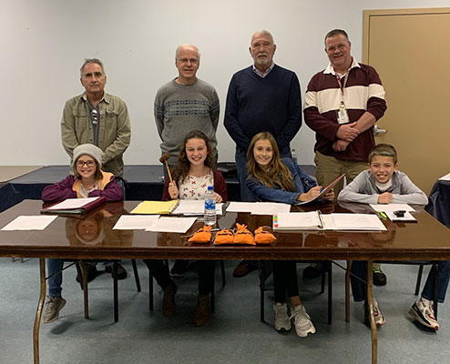 4 students with 3 board members and the mayor