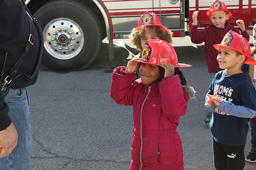 student wearing a fire helmet