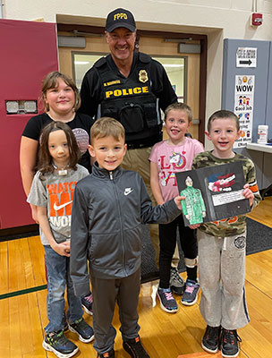 students standing with police officer 