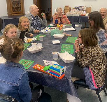 students and seniors playing bingo