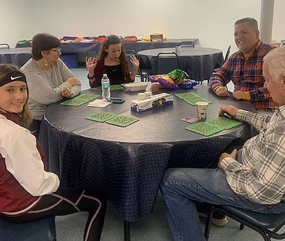 students and seniors playing bingo