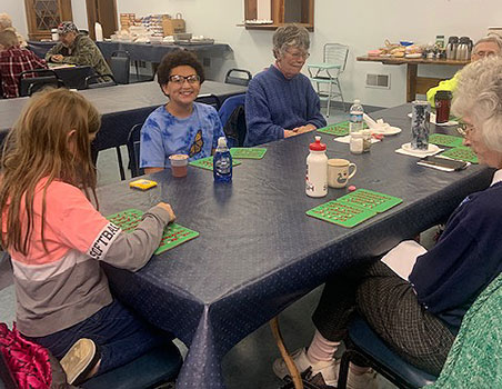 students and seniors playing bingo