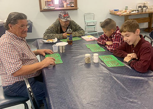 students and seniors playing bingo