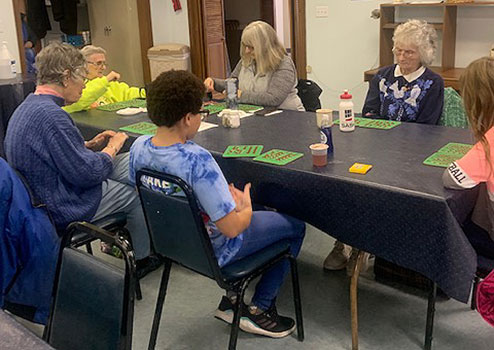 students and seniors playing bingo