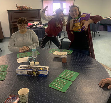 students and seniors playing bingo