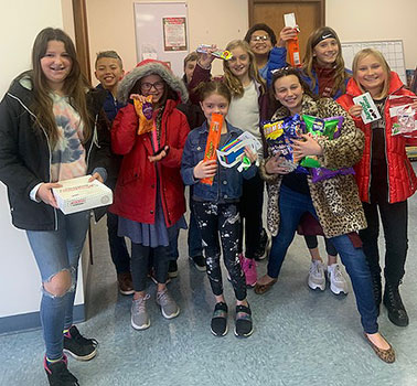 students standing in a group holding food and treats