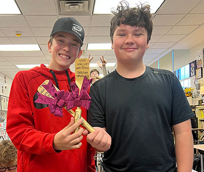 2 students holding award spatulas