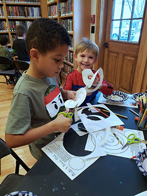 2 students creating their paper snow persons