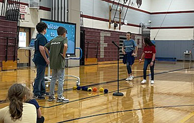 4 students role playing in gym