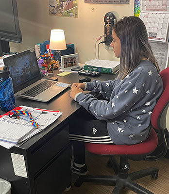 Olivia seated at computer