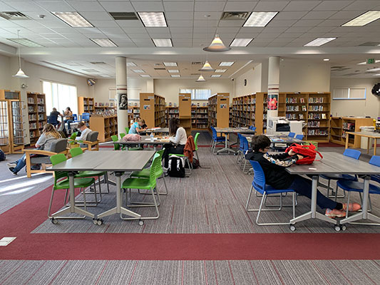 students seated at tables in library 