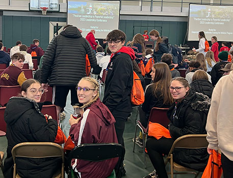 students seated in their chairs at the conference