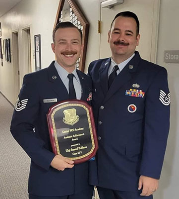 Samuel Hoffman holding plaque, standing with Air Force colleague